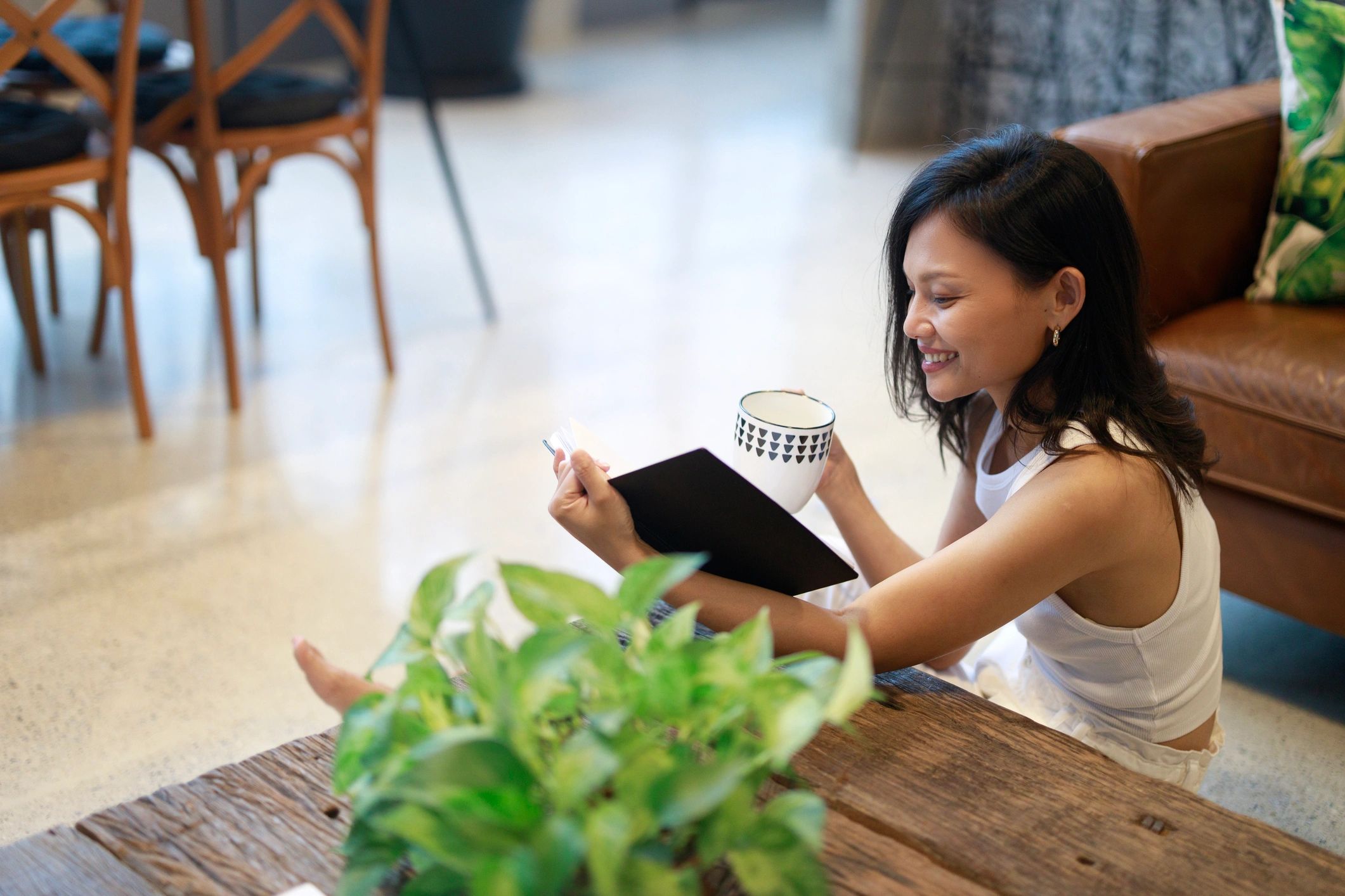 Woman reading with tea in a warm, reflective setting